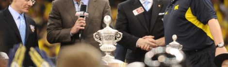 Allstate President Tom Wilson (far left) helps present Michigan coach Brady Hoke (far right) accepted the trophy for the Wolverines' victory in the 2012 Sugar Bowl.